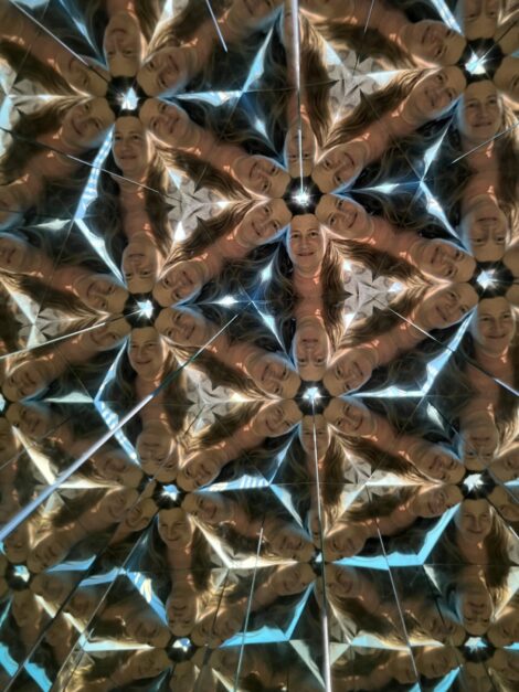 A brown and neon blue kaleidoscope of a face. Photo taken at the Museum of Illusions St Louis.