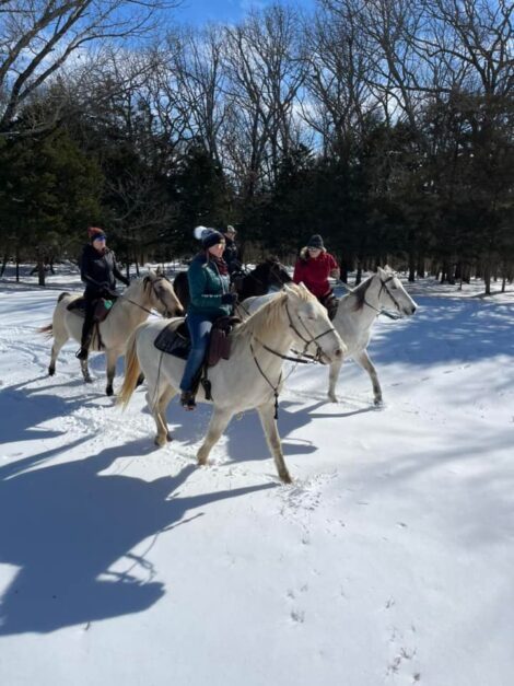 Horseback riding in winter snow.