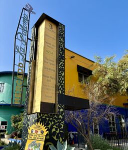 The brightly painted yellow facade of Mercado La Paloma