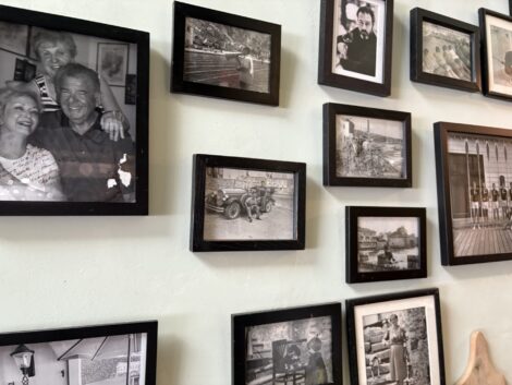 One wall of Divino covered with black framed family photos.